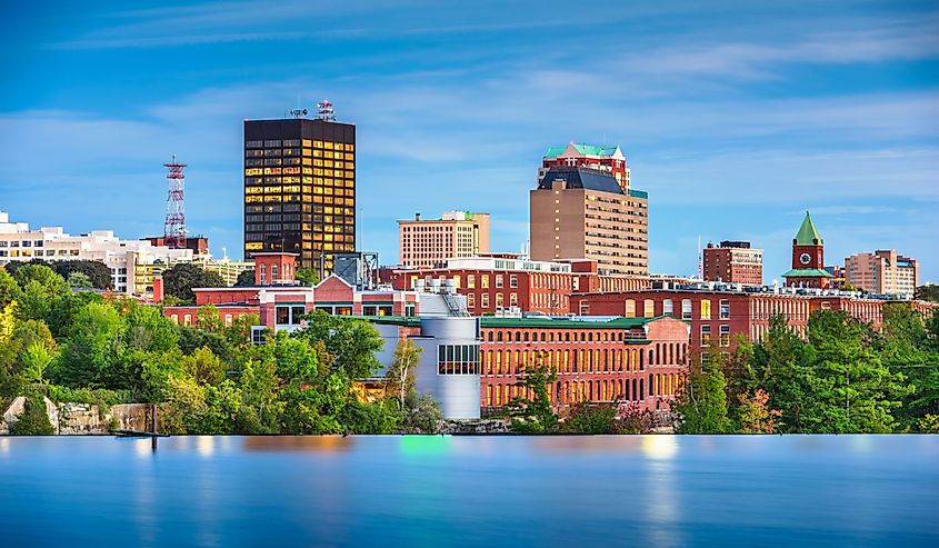 Manchester, New Hampshire, USA Skyline on the Merrimack River at dusk.