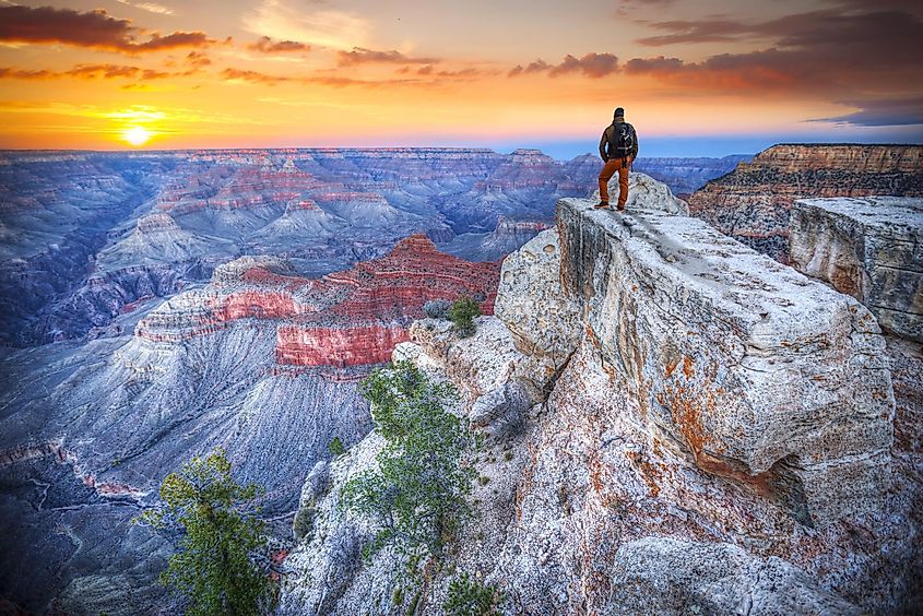 Man in the Grand Canyon at sunrise. Tourist in America