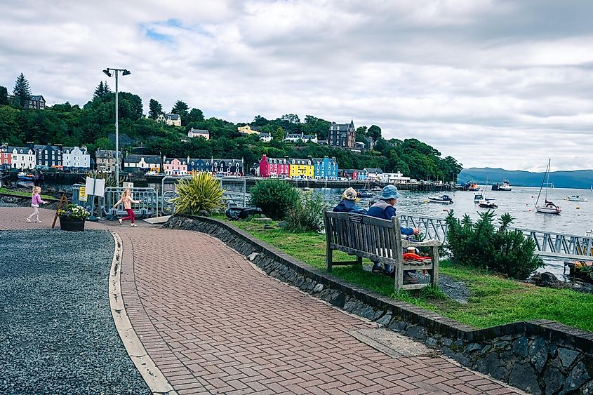  Tobermory, Isle of Mull, Scotland: People enjoying the view of the sea from the pier, with kids playing around.
