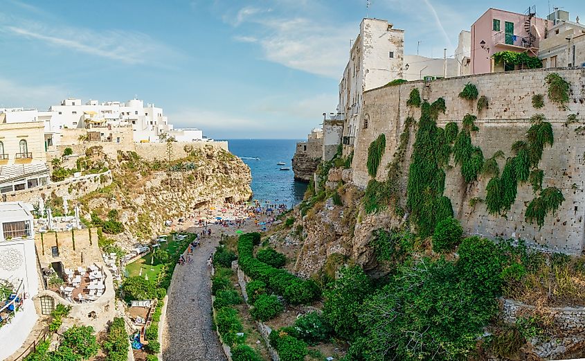 Historic cliffside houses above the turquoise Adriatic waters in Polignano a Mare, Italy.