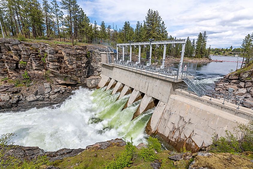 The Avista Dam at Falls Park along the Spokane River with roaring rapids in the rural town of Post Falls, Idaho