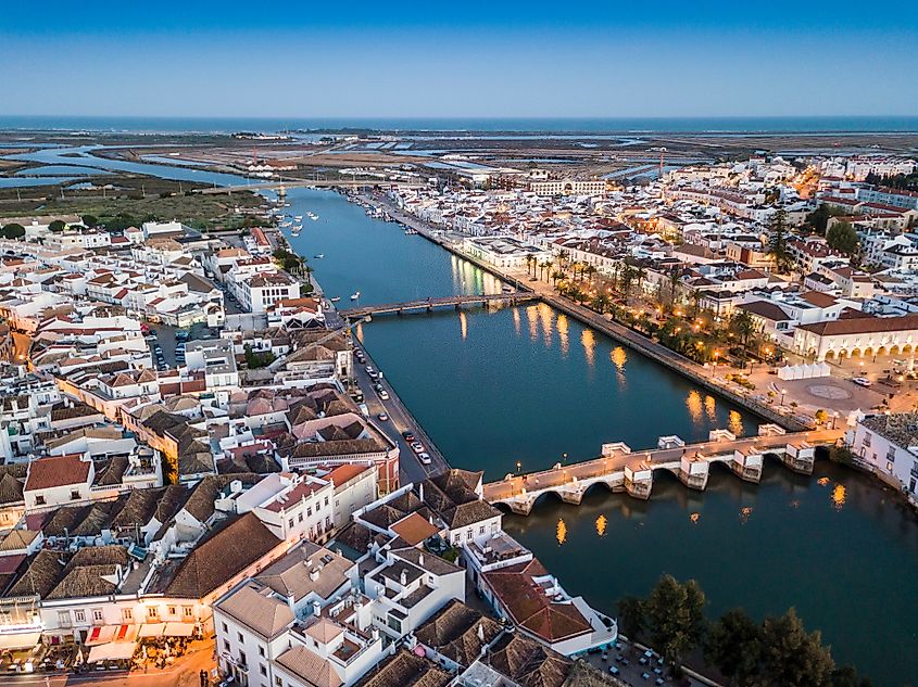 Aerial cityscape of beautiful Tavira with roman bridge over Gilao river in the evening, Algarve, Portugal