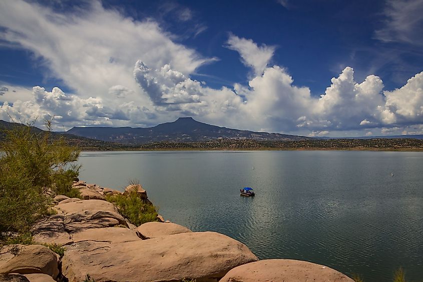 Summer day with a boat on a lake near Abiquiu, New Mexico and Cerro Pedernal