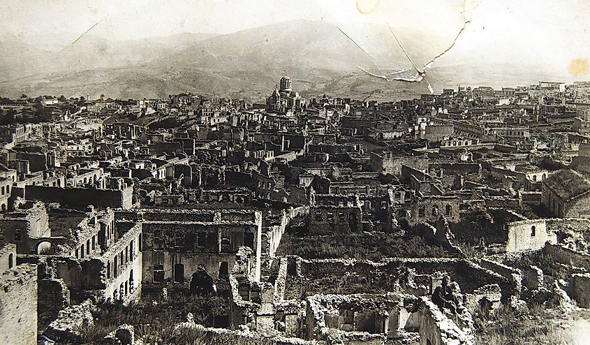 Shusha's Armenian quarters in the aftermath of their destruction by Azerbaijani army in March 1920. In the background: defiled Cathedral of the Holy Savior and Aguletsots church. By Unknown, possibly Zhamharian family from Shusha - Armenian Genocide Museum-Institute, Yerevan, Armenia, Public Domain.