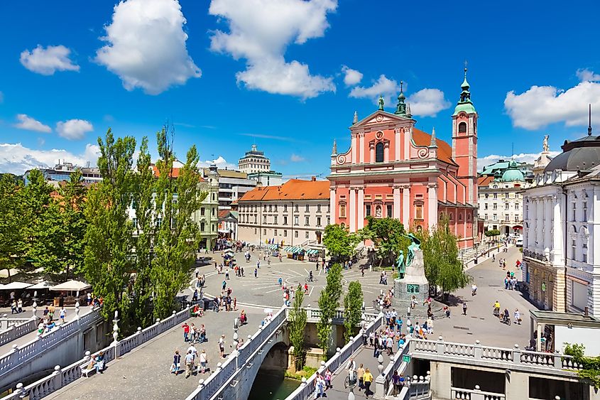 river Ljubljanica, Triple Bridge (Tromostovje), Preseren square and Franciscan Church of the Annunciation; Ljubljana, Slovenia, Europe.