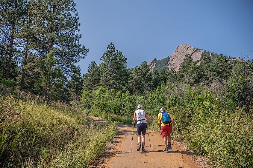 A senior couple hikes at the famous Chautauqua Park Hiking Area in Boulder, Colorado