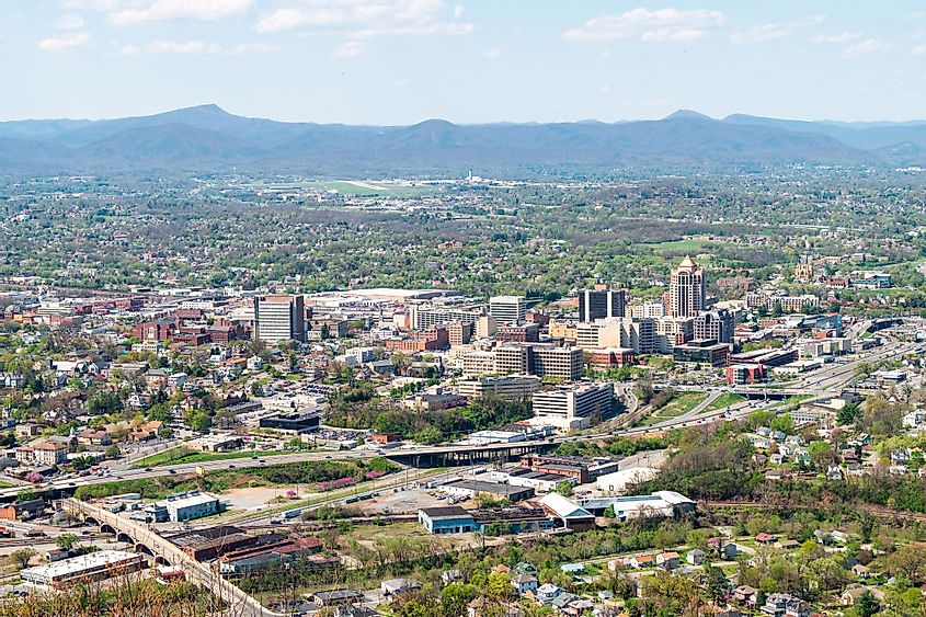 Aerial cityscape downtown office view in Roanoke, Virginia with business buildings and mountains highway