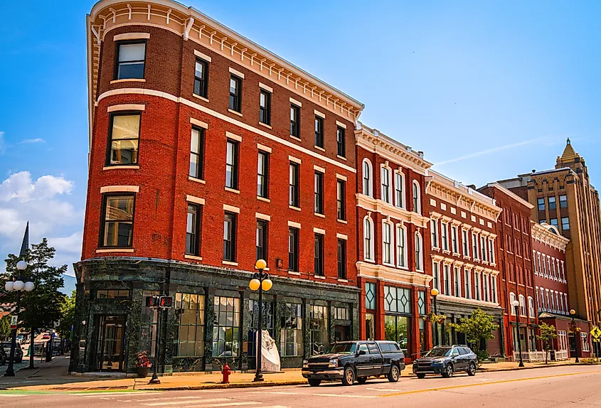 Historic downtown buildings and streetlamps along the sidewalk in Rutland, Vermont. 