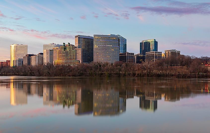 Cityscape of buildings in Arlington County, Virginia reflecting in the water of the Potomac River in morning light.