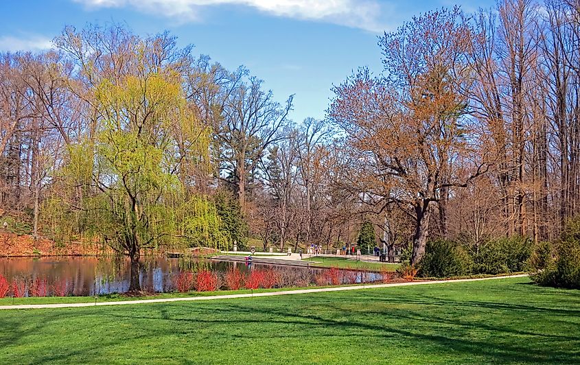 Scenic walk around the lake at Longwood Gardens in Kennett Square, Pennsylvania, with spring reflections in the water.