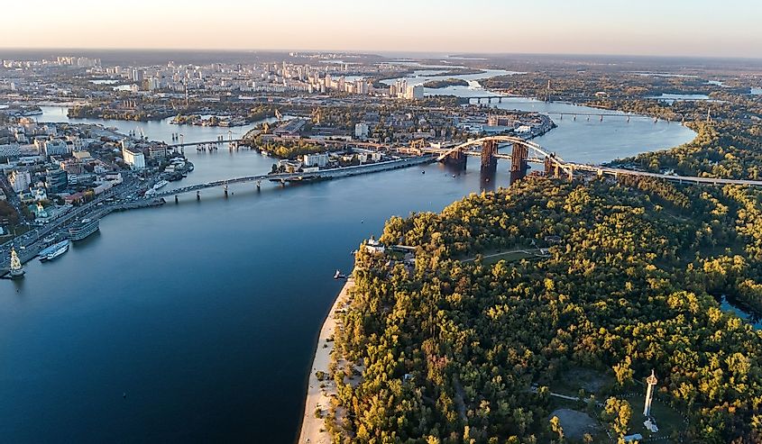 Aerial top view of Kyiv skyline, Dnieper river and Truchaniv island from above, sunset in Kiev city, Ukraine