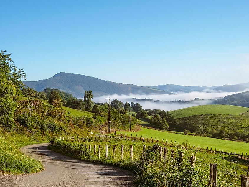 A footpath winds up through the hills of a verdant valley in Southwestern France