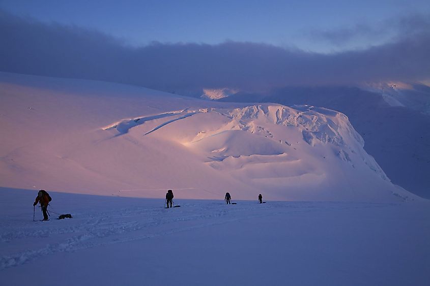 Mountaineering team ascending the upper Kahiltna Glacier at around midnight, in Denali National Park, Alaska