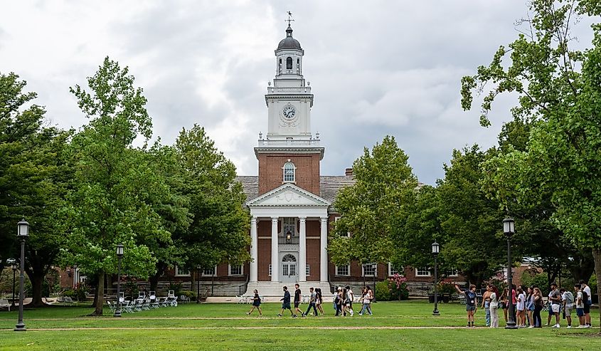 New students walk past Gilman Hall on the Johns Hopkins University campus during first year orientation.