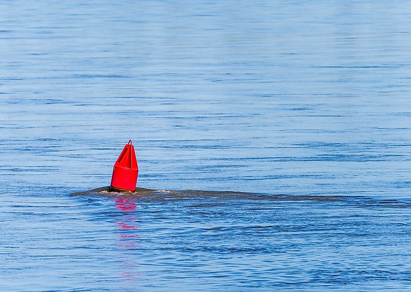 Low water levels in the lower Mississippi river with red navigation buoy. Credit: Steve Heap/Shutterstock.com
