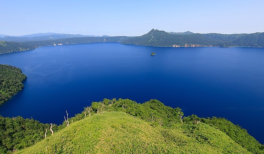 Lake Mashu, panoramic view of a serene blue lake in Hokkaido's caldera.