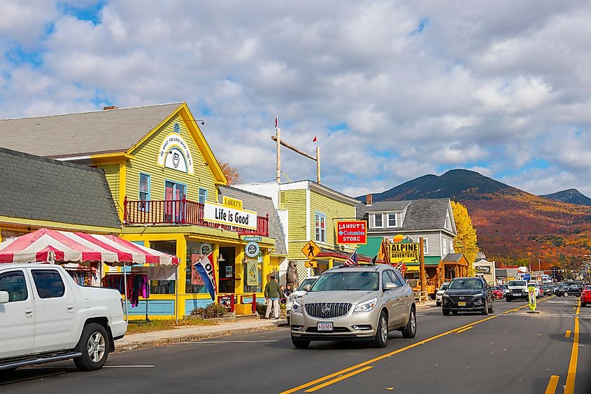 NEW HAMPSHIRE, USA - OCT. 14, 2019: Lincoln Main Street at town center and Little Coolidge Mountain on Kancamagus Highway at the background with fall foliage, Town of Lincoln, New Hampshire NH, USA.