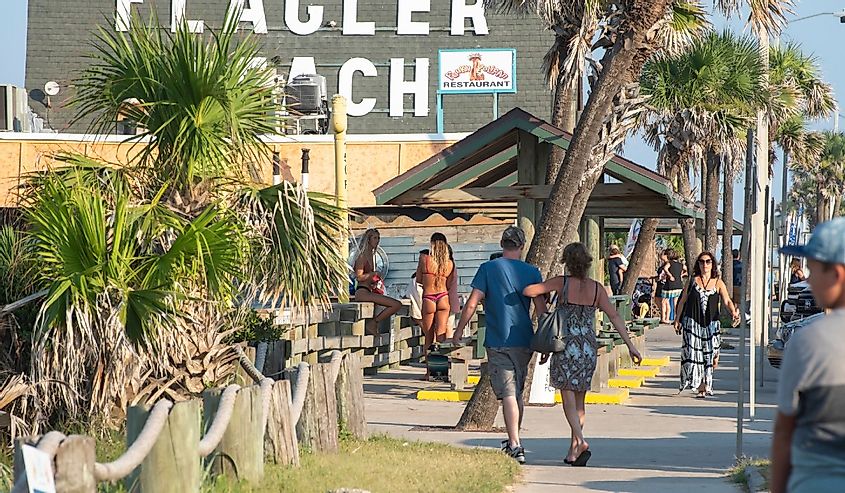 Visitors to Flagler Beach gather around the pier as the sun begins to set.