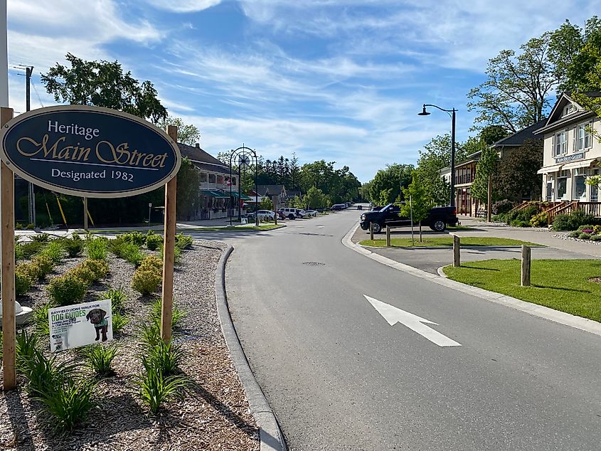 A blue sign marks the start of a small town's Heritage Main Street district.
