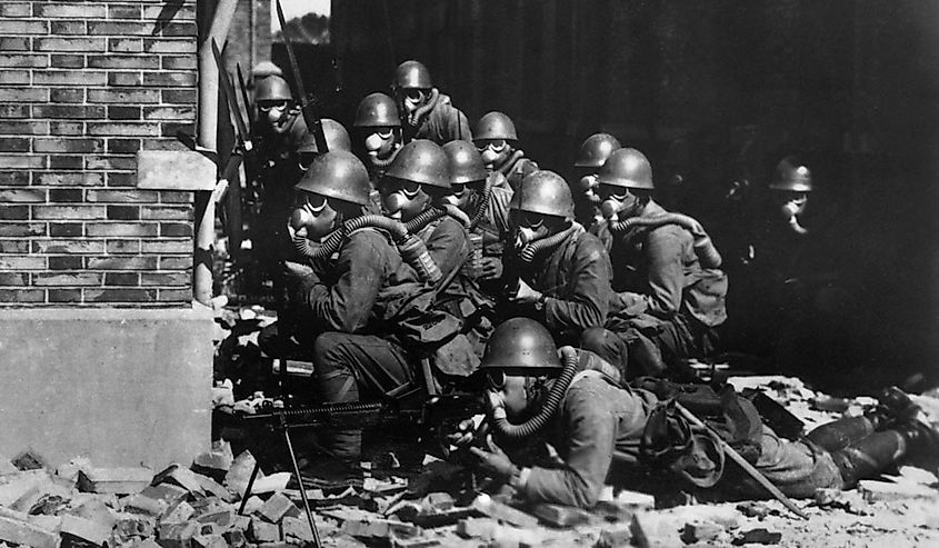 The Imperial Japanese Navy (IJN) Special Naval Landing Forces troops in gas masks prepare for an advance in the rubble of Shanghai, China.