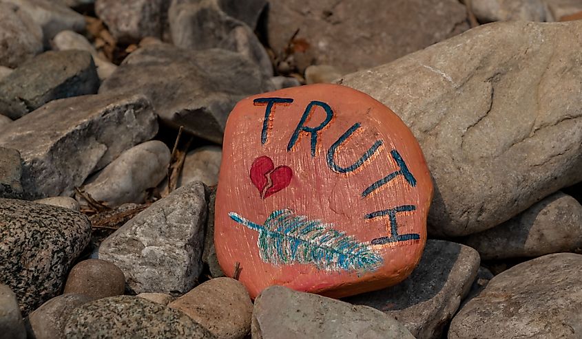 Orange painted rock along the Kagawong River trail to Bridal Veil Falls on Manitoulin Island.