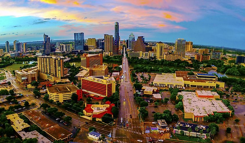 Aerial Drone Panoramic view from high above Austin Texas USA skyline cityscape over south congress or Soco downtown sunset view with pinks and colorful dramatic evening sky
