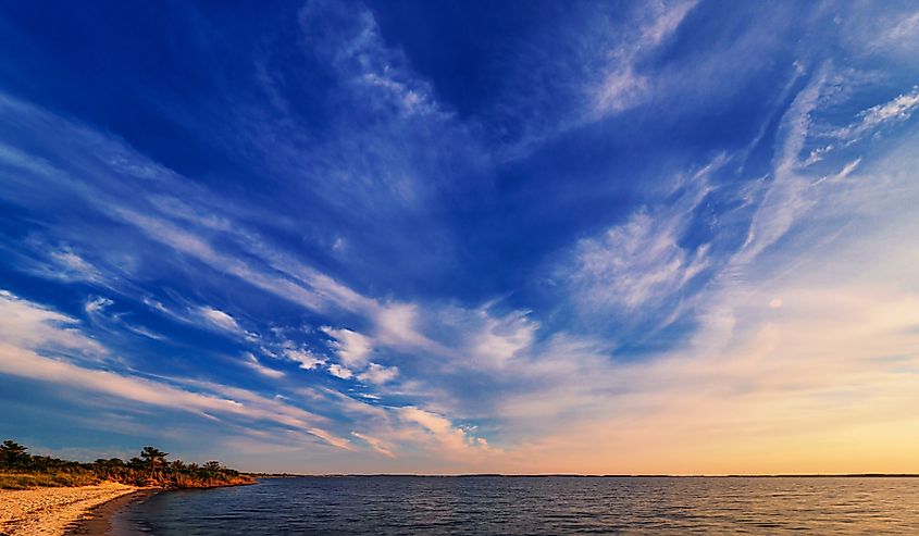 As twilight begins a dramatic sky unfolds before an empty beach at Rehoboth Bay, Delaware.