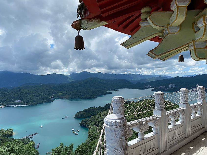 A bird's eye view of an alpine lake from atop a Buddhist pagoda.