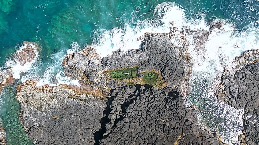 Resting in Queen's Bath in Princeville, Hawaii.