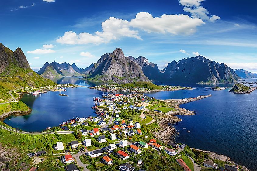 The village of Reine under a sunny, blue sky, with the typical rorbu houses. View from the top