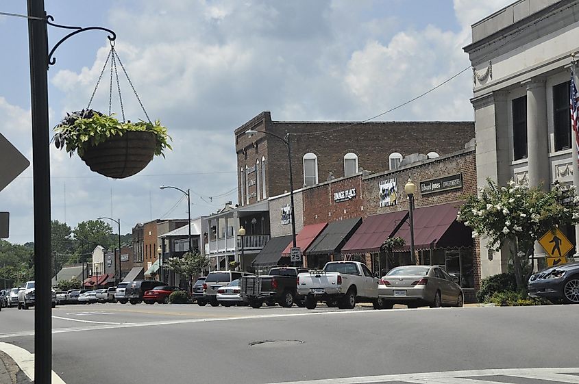 Bankhead Street, the main thoroughfare through the business district of a small southern town, lined with shops and parking available in the middle of the street.