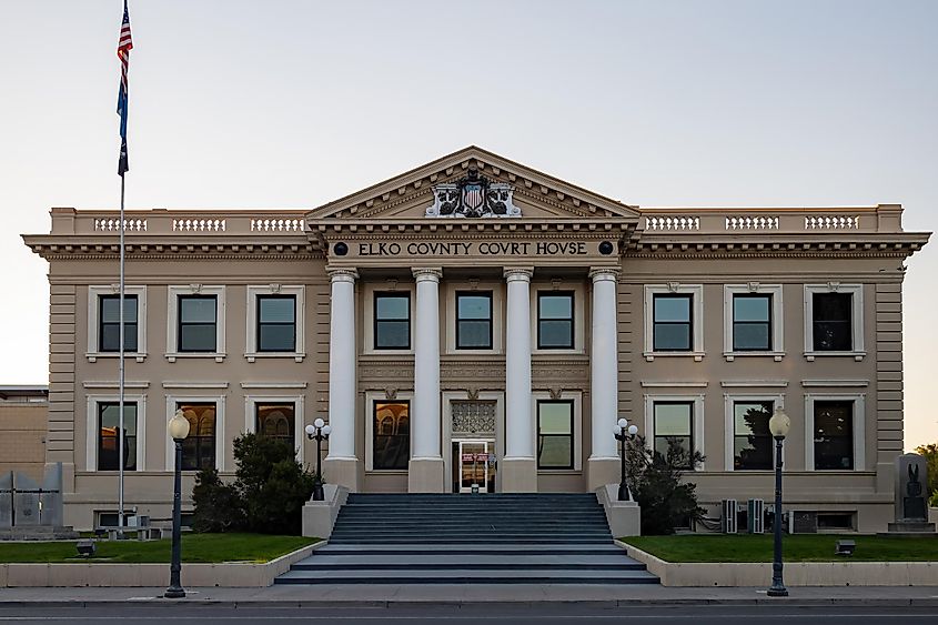 Afternoon view of the Elko County Courthouse, featuring its distinctive architecture and the serene ambiance of its surroundings.