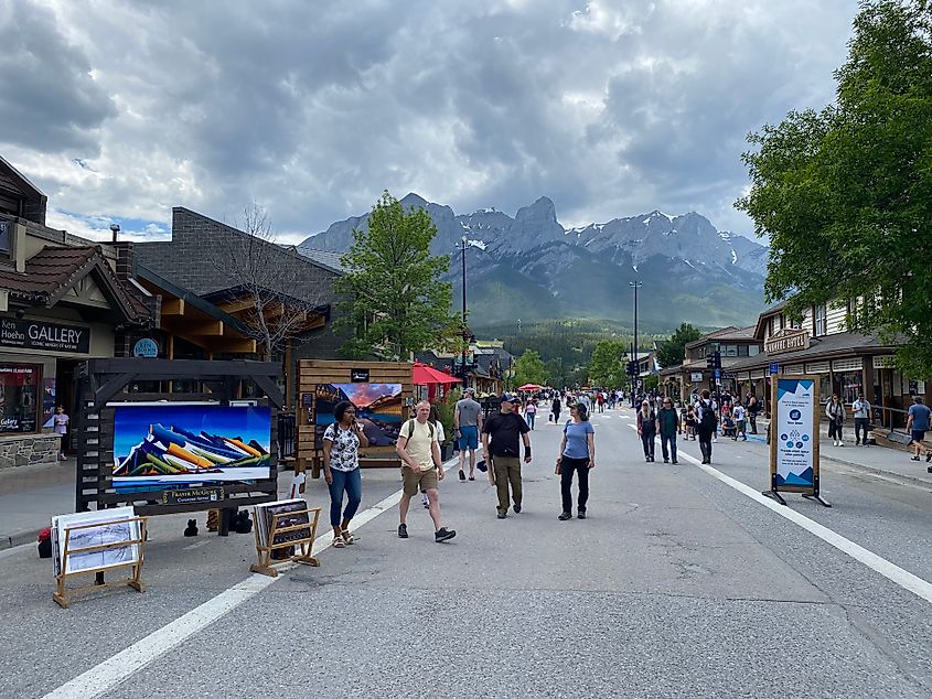 A pedestrian street in a mountain town, filled with mountain-themed street art.