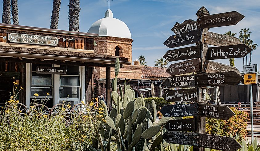 San Juan Capistrano, California with signs and cactus.