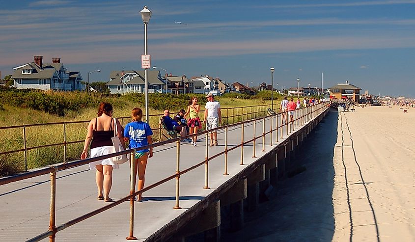 Folks enjoy a summer's day leisurely strolling on the boardwalk in Spring Lake, New Jersey