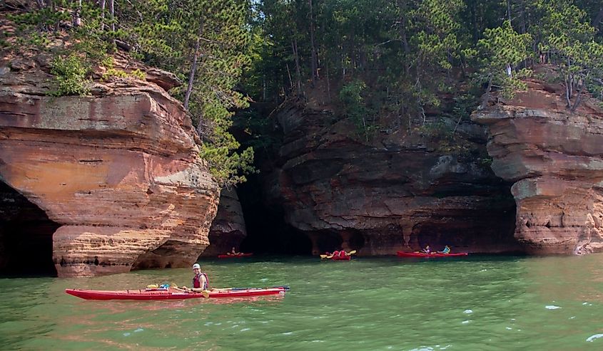 Kayakers enjoy the Apostle Island National Sea Caves in Bayfield, Wisconsin