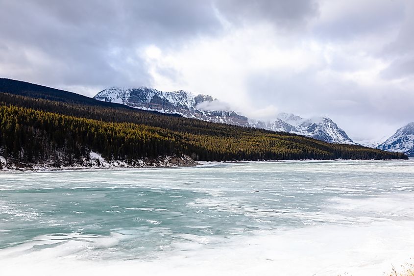 Lake Sherburne, created after the damming of Swiftcurrent Creek, is seen here frozen over in late winter. NPS Photo / Andrew Friedgen