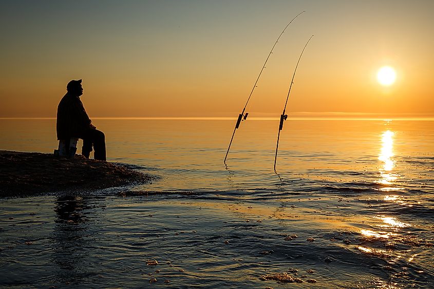 Sunset on  Lake Superior near Pictured Rock National Lake Shore Michigan State with silhouette of fisherman.