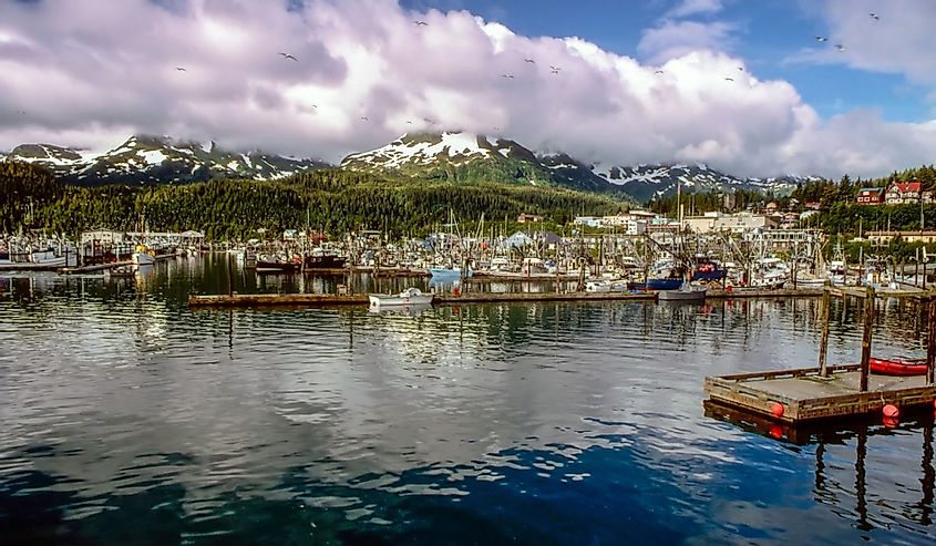 Harbor in Cordova, Alaska with clouds and mountains in the background