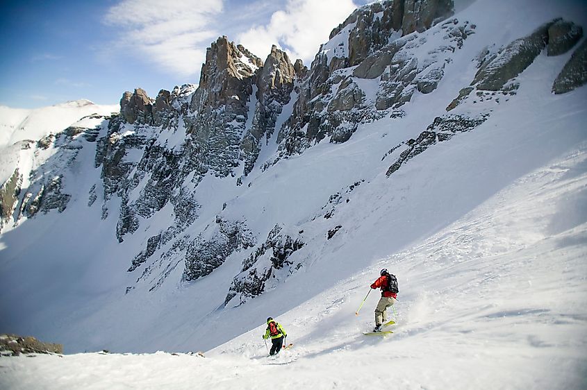 Two skiers descend Mountain Quail ski run at the Telluride Ski Resort, Telluride, Colorado. Editorial credit: DBSOCAL / Shutterstock.com