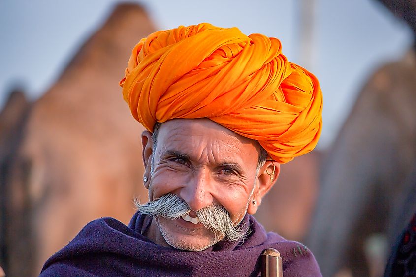 Pushkar, Rajasthan, India - November 15, 2018 Portrait of a Rajasthani Indian man dressed in traditional attire with turban (Pagadi) on his head at Pushkar camel Fair (Pushkar Mela)