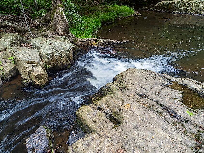 From a bird's-eye view, a silky-smooth waterfall elegantly winds between the rocks in Prince William Forest Park, Virginia.