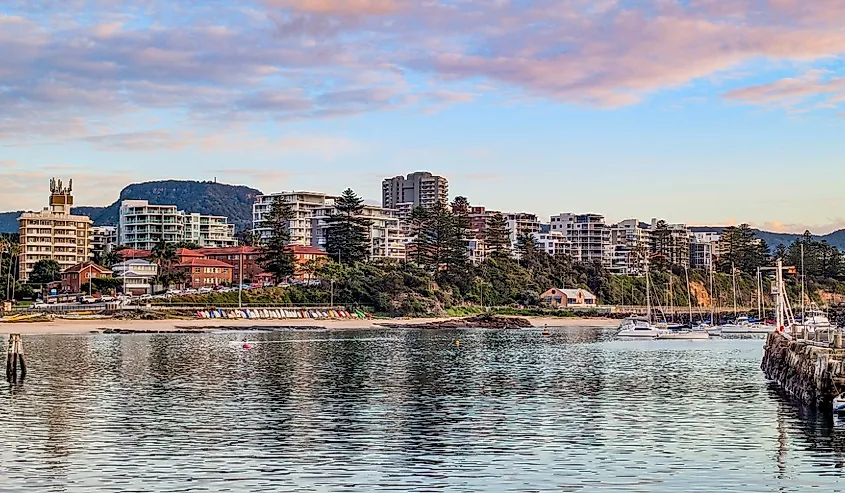 Coastal cityscape with a line of apartment buildings overlooking a harbor along the Blue Mile Pathway, North Wollongong.