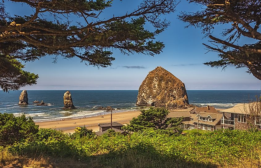 Landscape of Cannon Beach, Oregon, USA, with blue sky and rocks on the shore on a sunny summer day along the Oregon Coast. Travel photo with copyspace for text.