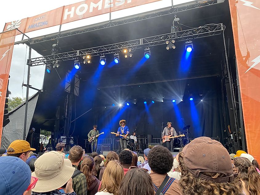 A four piece rock band called Arcy Drive plays to a packed festival crowd.