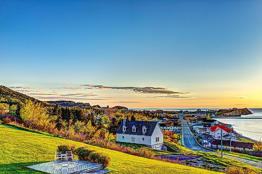 Hotel chairs on hill during sunrise in Perce, Gaspe Peninsula, Quebec, Canada