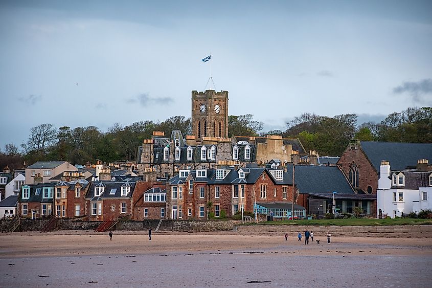 Seaside view of North Berwick, Scotland, showcasing historic buildings and sandy beach. 