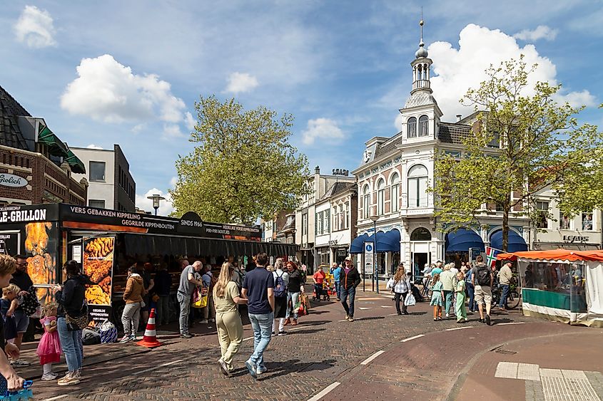 People walk past food stalls in the pleasant center of Assen (Editorial credit: Wolf-photography / Shutterstock.com)