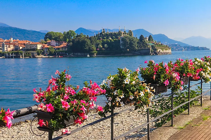 Scenic view of Isola Bella island on Lake Maggiore from the flower-covered waterfront promenade in Stresa, Piedmont, Italy.