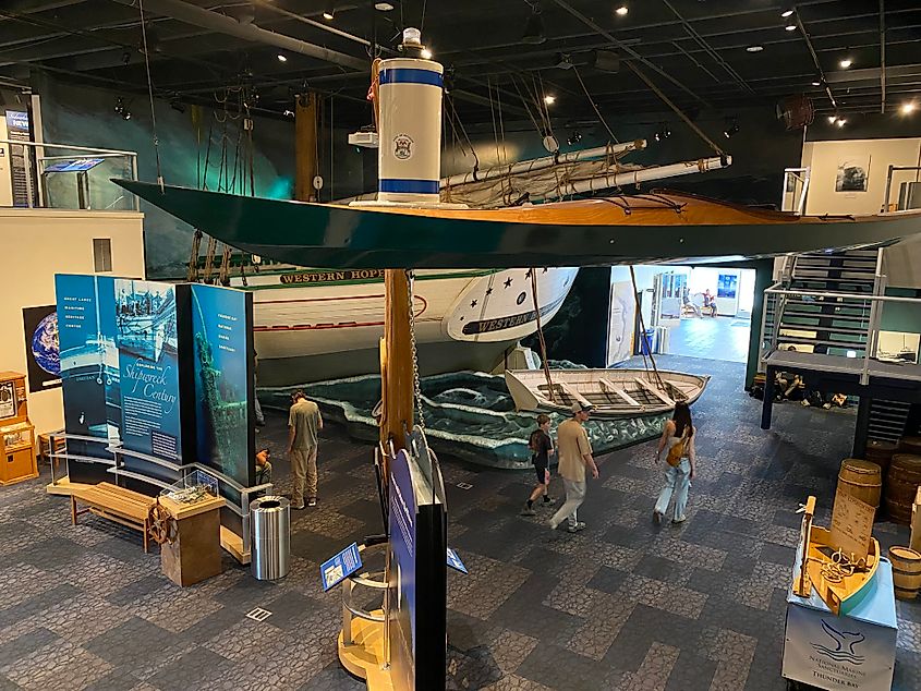 Museum goers explore a large exhibit centered around shipwrecks and maritime heritage.